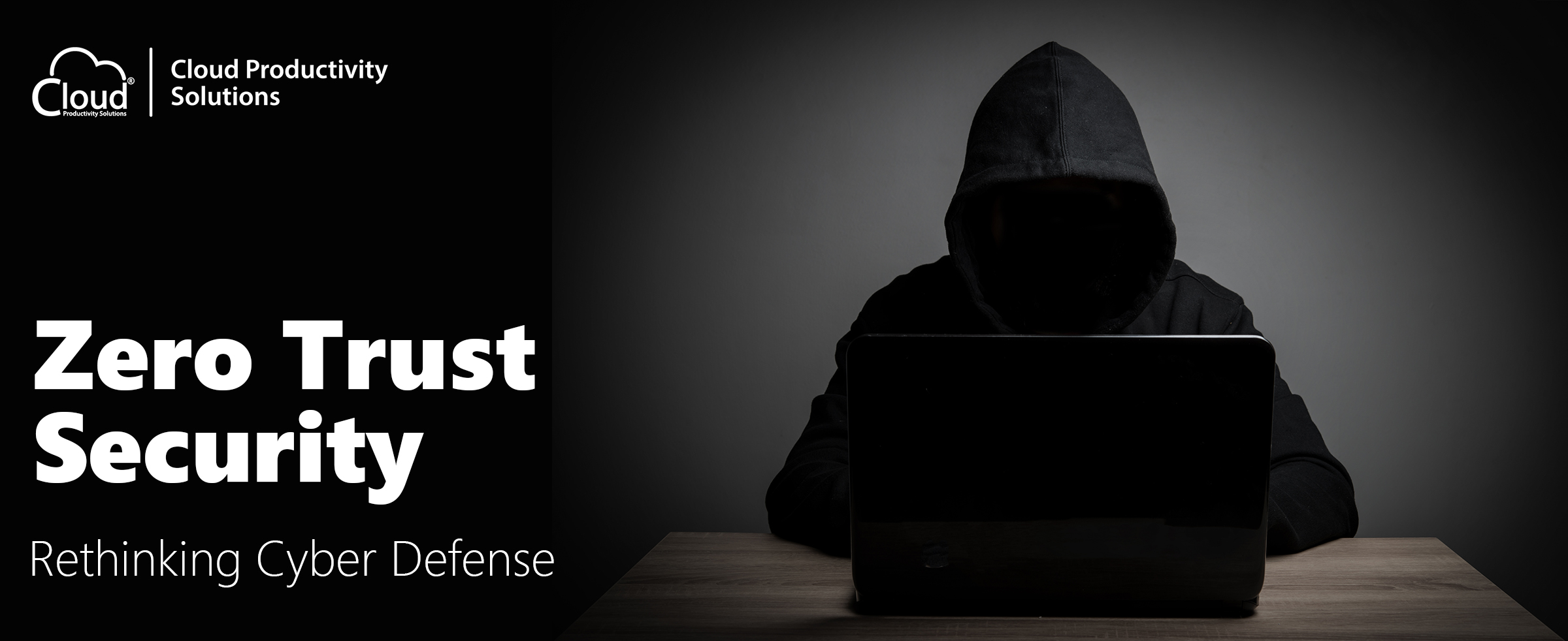 hacker in a dimly lit workstation wearing a black hoodie